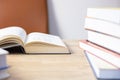 Close up and selective focus photo of science textbook opening page and stacks of many books as foreground and beautiful sunlight