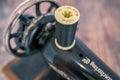 Spool of black cotton on a hand sewing machine Royalty Free Stock Photo