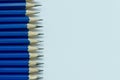 Close up and selective focus row of blue pencils on white background. Royalty Free Stock Photo