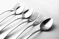 Close-up and selective focus of a set of cutlery on a white background. Flat spoon and top view of spoon, fork and knife with copy