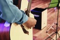 Selective focus shot image of hand playing acoustic guitar