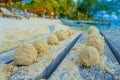 Close up of selective focus of small balls of sand after crabs lunch over a wooden structure in the beach of isla
