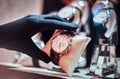 Close-up of the seller`s hand in gloves shows the exclusive men`s watch from the new collection Royalty Free Stock Photo