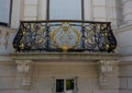 A close-up on semi-circled balcony with wrought iron railings