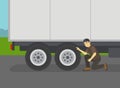 Close-up of semi-trailer driver checking the tires. Maintain and inspect tires.