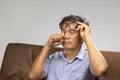 Senior asian man has eyestrain and fatigue Royalty Free Stock Photo