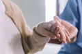 Close-up senior Asian woman hand with her caregiver helping hands holding together, Caregiver visit at home. Home health care. Royalty Free Stock Photo