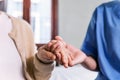 Close-up senior Asian woman hand with her caregiver helping hands, Caregiver visit at home. Home health care and nursing home Royalty Free Stock Photo
