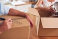 Close Up Of Senior Couple Downsizing In Retirement Boxes Ready For Move Into New Home Royalty Free Stock Photo