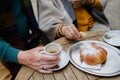 Close-up of senior couple enjoying cup of coffee and cake outdoor in cafe. Royalty Free Stock Photo