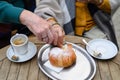 Close-up of senior couple enjoying cup of coffee and cake outdoor in cafe. Royalty Free Stock Photo