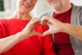 Close up of senior couple showing hand heart sign Royalty Free Stock Photo