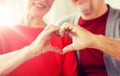 Close up of senior couple showing hand heart sign Royalty Free Stock Photo