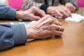 Close up of a senior group playing bingo at Nursing home. leisure game, support, assisted living, and retirement.