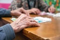 Close up of a senior group playing bingo at Nursing home. leisure game, support, assisted living, and retirement.