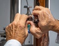 Elderly Hands Repairing Plumbing Pipe with Wrench Royalty Free Stock Photo