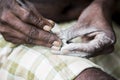 Close up of senior indian asian man sculptor carver hands working on his marble sculpture with chisel.