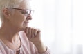 Close up of senior lady with glasses reading at home Royalty Free Stock Photo
