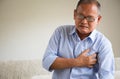 Close Up senior male asian suffering from bad pain in his chest heart attack at home. Healthcare and medical concept of senior Royalty Free Stock Photo