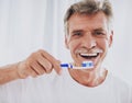 Close up. Senior Man Brushing Teeth in Bathroom.