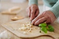 Close up of senior man cutting garlic. Royalty Free Stock Photo