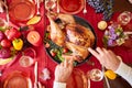 Close-up old man serving roasted turkey on a table background. Thanksgiving dinner. Traditional festive food concept.