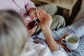 Close up of senior man giving medicines to his ill wife. Royalty Free Stock Photo