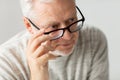 Close up of senior man in glasses thinking Royalty Free Stock Photo