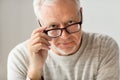 Close up of senior man in glasses thinking