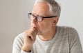 Close up of senior man in glasses thinking Royalty Free Stock Photo