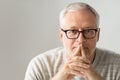 Close up of senior man in glasses thinking Royalty Free Stock Photo