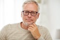 Close up of senior man in glasses thinking Royalty Free Stock Photo