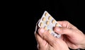 Close up of senior man hands holding pills Royalty Free Stock Photo