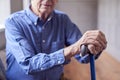 Close Up Of Senior Man At Home Resting Hands On Walking Stick Royalty Free Stock Photo