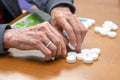 Close up of a senior man playing bingo at Nursing home. leisure game, support, assisted living, and retirement.