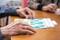 Close up of a senior man playing bingo at Nursing home. leisure game, support, assisted living, and retirement.