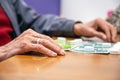 Close up of a senior man playing bingo at Nursing home. leisure game, support, assisted living, and retirement.