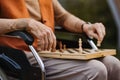 Close up of senior man playing chess outdoors alone. Royalty Free Stock Photo