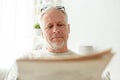 Close up of senior man reading newspaper at home Royalty Free Stock Photo