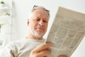 Close up of senior man reading newspaper at home Royalty Free Stock Photo