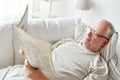 Close up of senior man reading newspaper at home Royalty Free Stock Photo