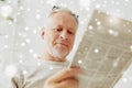 Close up of senior man reading newspaper at home Royalty Free Stock Photo