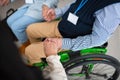 Close-up of senior man sitting in wheelchair at group therapy session. Royalty Free Stock Photo