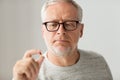 Close up of senior man taking medicine pill Royalty Free Stock Photo