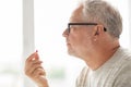 Close up of senior man taking medicine pill Royalty Free Stock Photo