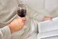 Close up of senior man with wine glass and book Royalty Free Stock Photo