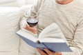 Close up of senior man with wine reading book Royalty Free Stock Photo