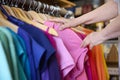 Close Up Of Senior Woman Buying Used Sustainable Clothes From Second Hand Charity Shop Or Thrift Store