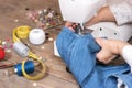 Close-up of senior woman hands seamstress sewing jeans on electrical sewing machine.