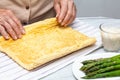 Close up of a senior woman hands stuffing a just baked sponge cake